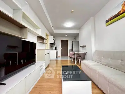 Modern living room with sleek furniture and open kitchen layout in a stylish apartment.