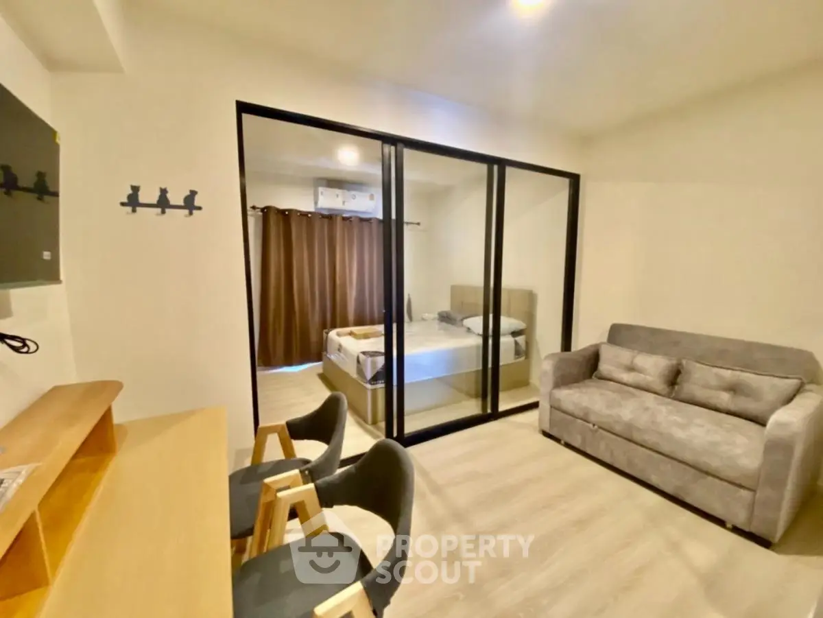 Modern studio apartment with glass partition and cozy furnishings