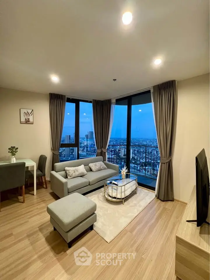 Spacious living room with stunning city view and modern furnishings