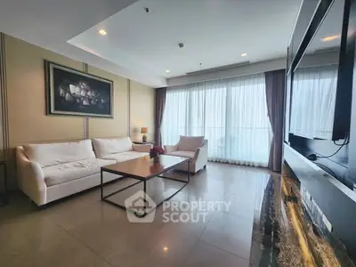 Spacious living room with modern decor and large windows offering natural light.