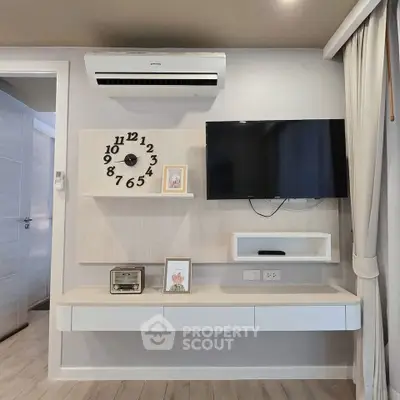 Modern living room with wall-mounted TV and air conditioning unit.
