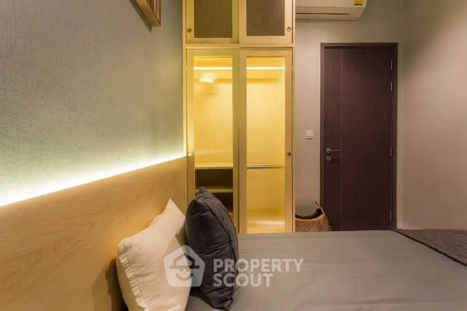 Modern bedroom with cozy lighting and built-in wardrobe