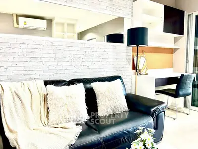 Modern living room with black leather sofa and stylish decor