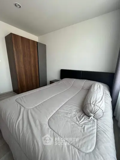 Modern bedroom with sleek wardrobe and cozy bedding