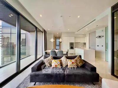 Luxurious modern living room with panoramic city views and stylish open kitchen.