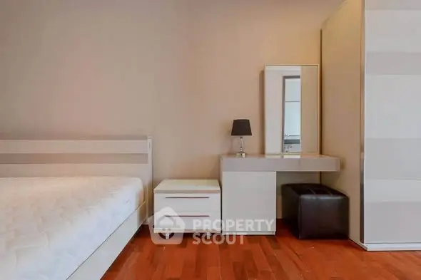Modern bedroom with sleek furniture and hardwood flooring