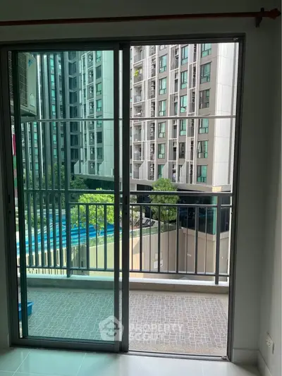 Modern apartment balcony with city view and sliding glass doors