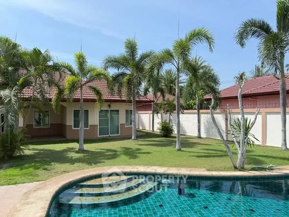Charming villa with lush garden and inviting pool, perfect for tropical living.
