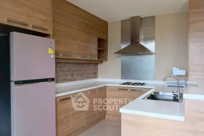 Modern kitchen with sleek wooden cabinets and stainless steel appliances
