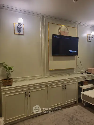 Elegant living room with wall-mounted TV and stylish lighting fixtures