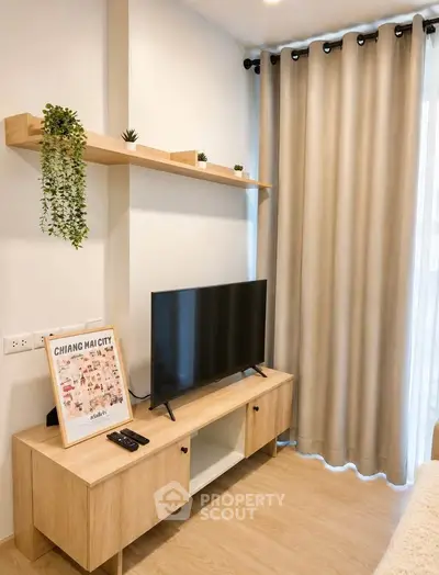 Modern living room with TV, wooden shelves, and stylish decor in a cozy apartment.