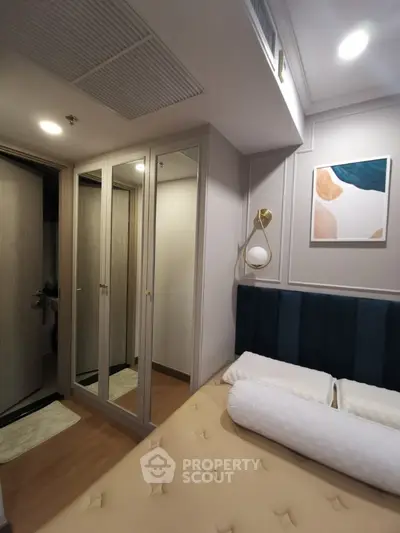 Cozy bedroom with elegant decor and mirrored wardrobe