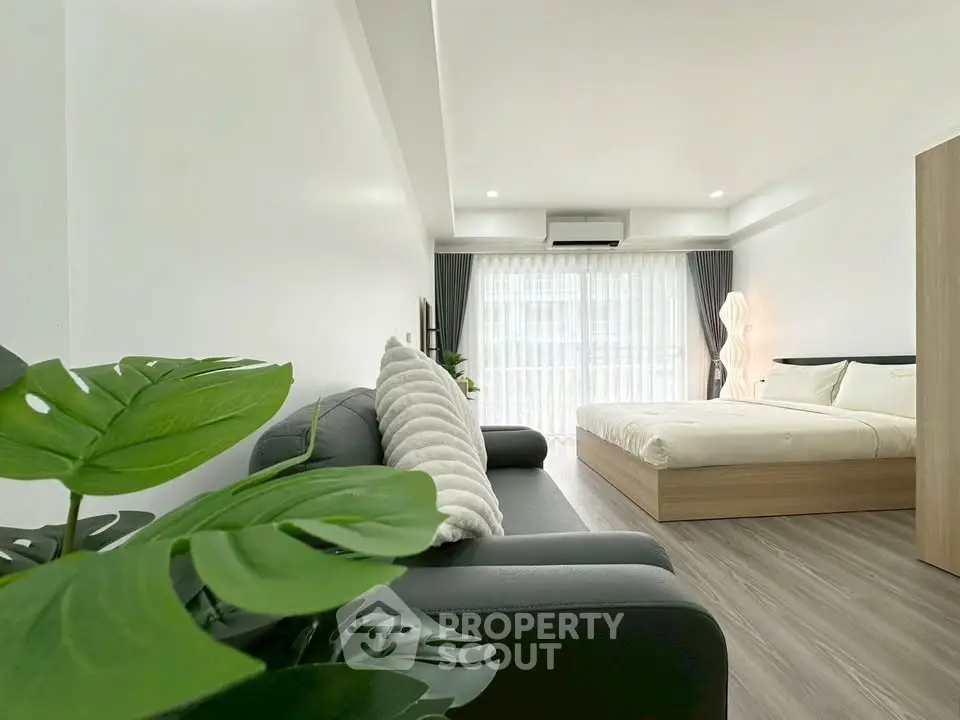 Modern studio apartment with cozy living area and stylish bedroom