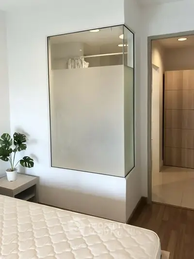 Modern bedroom with frosted glass partition and minimalist decor