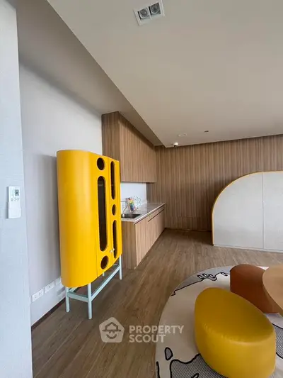 Modern living room with unique yellow furniture and wood paneling