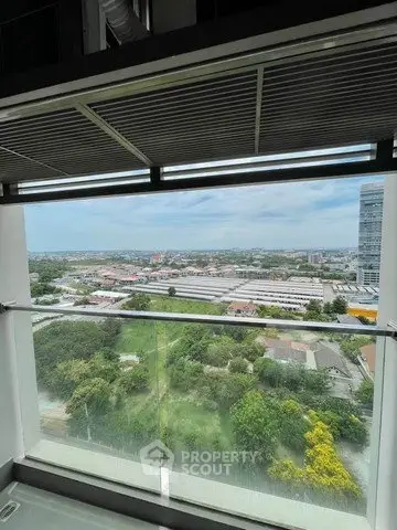 Stunning high-rise balcony view overlooking lush greenery and cityscape, perfect for urban living.