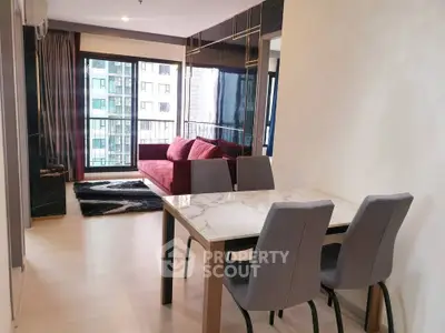 Modern living room with stylish dining area and large windows in a high-rise apartment.