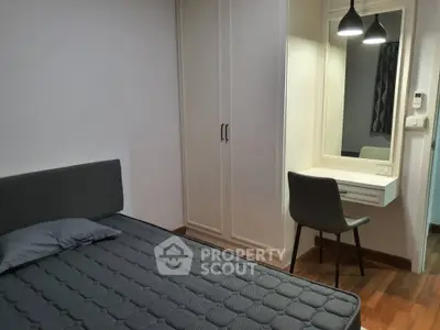 Cozy bedroom with modern furniture and built-in wardrobe