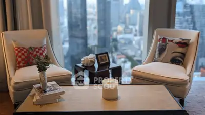 Elegant living room with city view, featuring stylish chairs and decor.