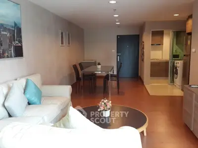 Spacious living room with modern decor and open layout in a stylish apartment.