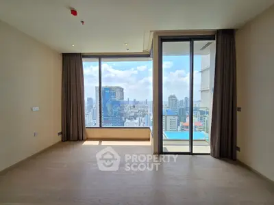 Spacious modern apartment with stunning city view and floor-to-ceiling windows.