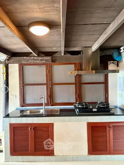 Charming rustic kitchen with gas stove and wooden accents, perfect for cozy home cooking.