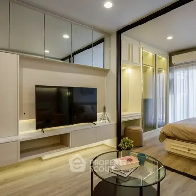 Modern living room with sleek TV setup and cozy bedroom view