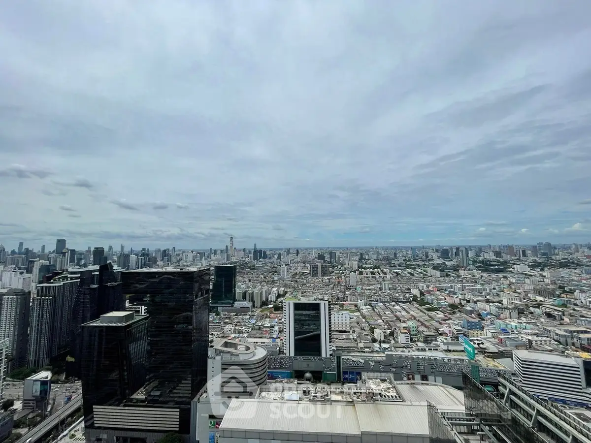 Stunning panoramic cityscape view from a high-rise building, showcasing urban skyline and vast city expanse.