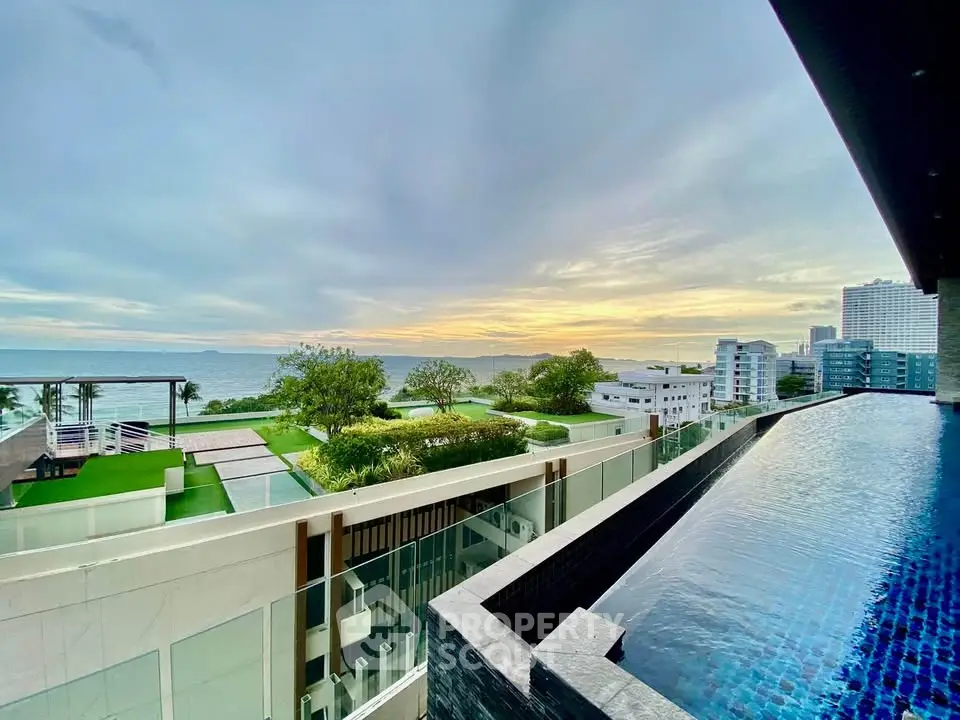 Stunning ocean view from luxury apartment balcony with infinity pool