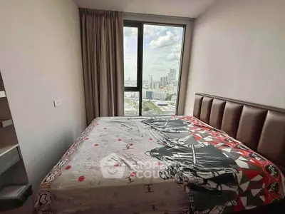 Cozy bedroom with city view, featuring a large window and stylish decor, perfect for urban living.