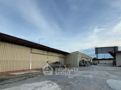Expansive industrial warehouse exterior with ample outdoor storage space.