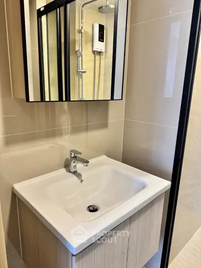 Modern bathroom with sleek sink and shower in contemporary apartment