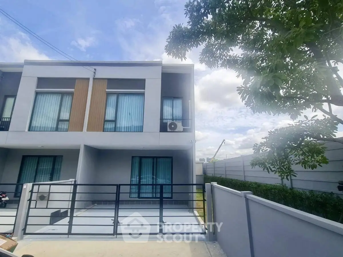 Modern townhouse with sleek design and spacious driveway in a serene neighborhood.