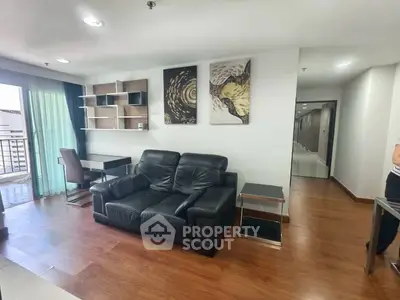 Modern living room with black leather sofa and stylish decor