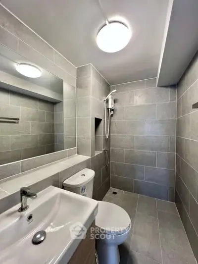 Modern bathroom with sleek gray tiles and contemporary fixtures