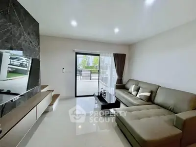 Modern living room with sleek furniture and large window for natural light.