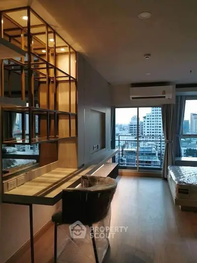 Modern bedroom with city view, featuring sleek furniture and large windows for natural light.