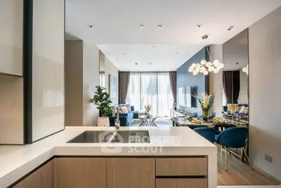 Luxurious open-plan living room with modern kitchen and elegant dining area, featuring stylish decor and ample natural light.