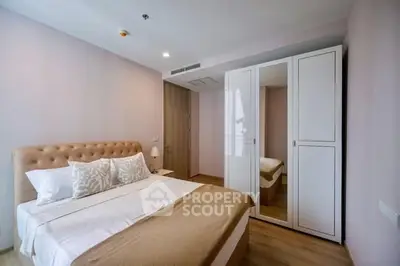 Modern bedroom with elegant decor and mirrored wardrobe