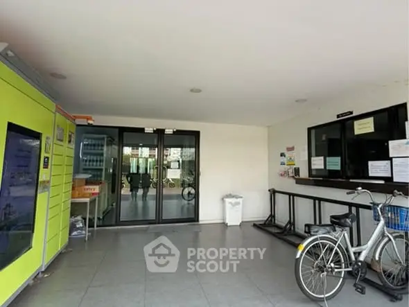 Modern apartment entrance with bicycle parking and secure access.