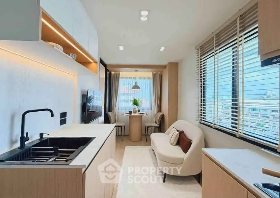 Modern kitchen and living area with sleek design and natural light