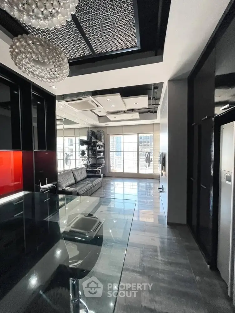 Luxurious modern living room with sleek design and large windows offering ample natural light.