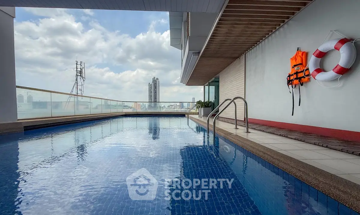 Luxurious rooftop pool with city skyline view and safety equipment