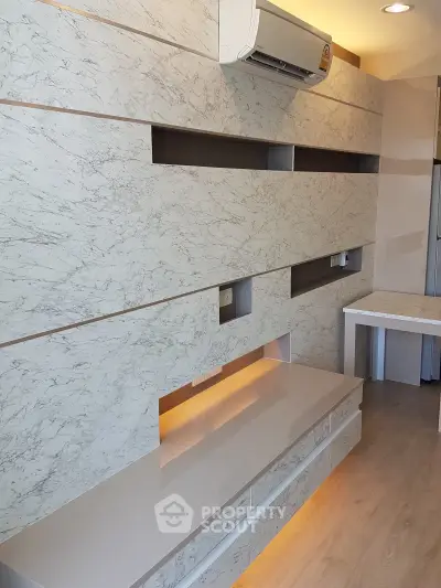 Modern living room with marble accent wall and built-in air conditioning unit