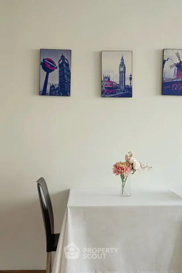 Charming dining nook with elegant decor and artistic wall art, perfect for cozy meals.