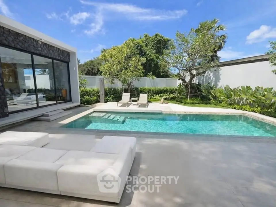 Luxurious modern villa with private pool and lush garden, perfect for relaxation and entertainment.