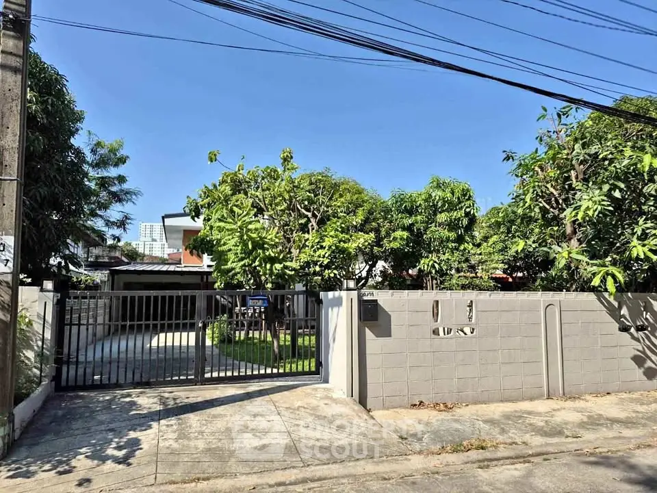Charming residential property with lush greenery and secure gated entrance