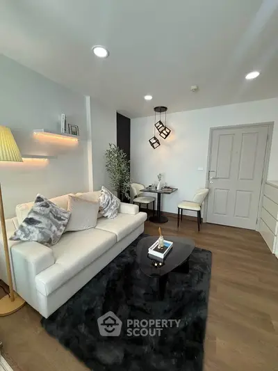 Modern living room with elegant decor, cozy seating, and stylish lighting in a contemporary apartment.