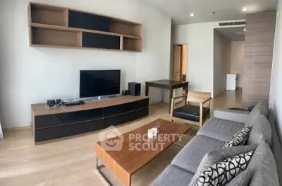 Modern living room with sleek furniture and entertainment center in stylish apartment.