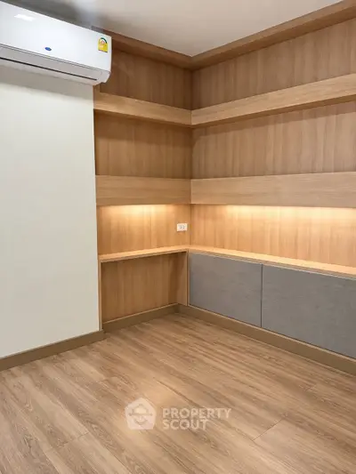 Modern study room with wooden shelves and sleek lighting